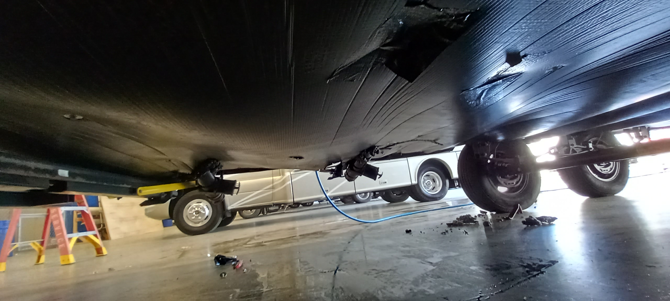 Placeholder frame — RV underbelly inspection bay, skid plate and exhaust routing awaiting forensic photo